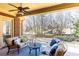 Relaxing covered patio featuring cozy seating, a ceiling fan, and views of the backyard at 5352 Lacosta Ln, Alpharetta, GA 30022