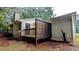 Back exterior view of a house showcasing the siding, deck, and surrounding yard at 5517 Green Wing Ct, Lithonia, GA 30058