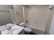 Full bathroom with a tub and shower combo, a white vanity, a mirror, and neutral paint at 5517 Green Wing Ct, Lithonia, GA 30058