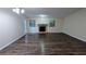 Spacious living room featuring a cozy stone fireplace, hardwood floors, neutral paint, and natural light at 5517 Green Wing Ct, Lithonia, GA 30058