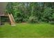 Backyard with stairs to deck and a lush lawn at 835 Navajo Trl, Covington, GA 30016