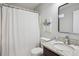 Bathroom featuring a shower with curtain, granite countertop, framed mirror, and modern fixtures at 835 Navajo Trl, Covington, GA 30016