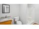 Bathroom featuring a shower, granite countertop, framed mirror, and modern fixtures at 835 Navajo Trl, Covington, GA 30016