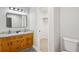 Bathroom featuring double sinks with granite countertops, new lighting, and closet space at 835 Navajo Trl, Covington, GA 30016