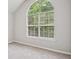 Bedroom features a large window letting in natural light, and neutral carpeting at 835 Navajo Trl, Covington, GA 30016