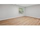 Bedroom featuring a window letting in natural light, hardwood flooring, and neutral colored walls at 835 Navajo Trl, Covington, GA 30016