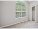 Bedroom features a large window letting in natural light, neutral carpeting, and a closet at 835 Navajo Trl, Covington, GA 30016