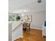 Open dining area features a hardwood floor, a modern light fixture, and large windows at 835 Navajo Trl, Covington, GA 30016