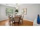 Dining room with modern light fixture and a round table at 835 Navajo Trl, Covington, GA 30016