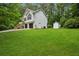 Split-level home featuring an attached two-car garage and well-maintained lawn at 835 Navajo Trl, Covington, GA 30016