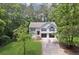 Aerial view of a traditional two-story home surrounded by mature trees and green lawn at 835 Navajo Trl, Covington, GA 30016