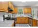Well-equipped kitchen featuring granite countertops, stainless steel appliances, and ample cabinet space at 835 Navajo Trl, Covington, GA 30016