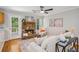 Inviting living room with a stone fireplace, wood floors, and a ceiling fan at 835 Navajo Trl, Covington, GA 30016