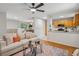 Inviting living room with hardwood floors, ceiling fan, and an open flow to the kitchen and dining area at 835 Navajo Trl, Covington, GA 30016