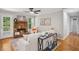 Cozy living room featuring a stone fireplace and a ceiling fan at 835 Navajo Trl, Covington, GA 30016