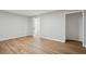 Living room featuring hardwood flooring, neutral colored walls, and doors leading to other rooms at 835 Navajo Trl, Covington, GA 30016
