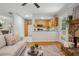Open-concept living area with a stone fireplace, kitchen view, and hardwood floors at 835 Navajo Trl, Covington, GA 30016