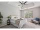 Serene main bedroom with tray ceiling, plush carpeting, and a view of the outdoors at 835 Navajo Trl, Covington, GA 30016