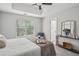 Relaxing main bedroom featuring a comfortable bed, tray ceilings, and soft, neutral colors at 835 Navajo Trl, Covington, GA 30016