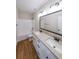 Well-lit bathroom with dual sinks, granite countertops, and tile flooring at 96 Lexie Ct, Rockmart, GA 30153