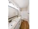 Bathroom with double vanity, granite countertop, and white cabinets over wood-look floors at 96 Lexie Ct, Rockmart, GA 30153