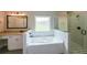 Bright bathroom features a soaking tub, glass-enclosed shower, and granite vanity at 96 Lexie Ct, Rockmart, GA 30153