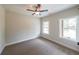 Bright bedroom features neutral walls, carpet, and two windows at 96 Lexie Ct, Rockmart, GA 30153