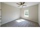 Inviting bedroom with neutral tones, cozy carpet, a modern ceiling fan, and a window providing outdoor views at 96 Lexie Ct, Rockmart, GA 30153
