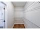 Well-organized walk-in closet with wire shelving and wood-look flooring adjacent to a sleek bathroom at 96 Lexie Ct, Rockmart, GA 30153