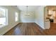 Dining area features wood-look floors, trim, and a modern chandelier, bathed in natural light at 96 Lexie Ct, Rockmart, GA 30153