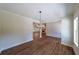 Dining area with wood-look floors and chandelier, and a view into the adjacent living room at 96 Lexie Ct, Rockmart, GA 30153