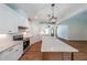Spacious kitchen with white cabinets, a granite countertop, stainless steel appliances, and modern pendant lights at 96 Lexie Ct, Rockmart, GA 30153