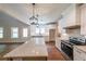 Modern kitchen with white cabinets, stainless steel appliances, a large island, and wood-style flooring at 96 Lexie Ct, Rockmart, GA 30153