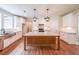 Bright kitchen with white cabinets, granite countertops, wooden floors, and an island with pendant lighting at 96 Lexie Ct, Rockmart, GA 30153