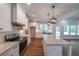 Modern kitchen with granite countertops, a central island, and stainless steel appliances at 96 Lexie Ct, Rockmart, GA 30153