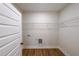 Practical laundry room featuring wood-look flooring, washer/dryer hookups, and wire shelving for storage at 96 Lexie Ct, Rockmart, GA 30153