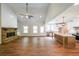 Open-concept living room with a stone fireplace, high ceilings, and a seamless flow to the kitchen at 96 Lexie Ct, Rockmart, GA 30153
