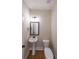 Stylish powder room featuring a pedestal sink, modern mirror, and wood-look flooring for a contemporary feel at 96 Lexie Ct, Rockmart, GA 30153