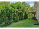 Lush backyard featuring well-maintained lawn, mature trees, and the home's exterior at 1039 Megan Ct, Sugar Hill, GA 30518