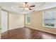 Comfortable bedroom with modern flooring, a ceiling fan, and natural light from large windows at 1039 Megan Ct, Sugar Hill, GA 30518