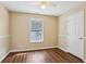 Bedroom featuring wood-look floors, a ceiling fan and natural light from the window at 1039 Megan Ct, Sugar Hill, GA 30518