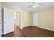 Bedroom featuring wood-look floors, a ceiling fan and access to other rooms at 1039 Megan Ct, Sugar Hill, GA 30518