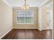 Empty dining room with bright windows, and adjacent foyer view at 1039 Megan Ct, Sugar Hill, GA 30518