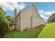 Beige home featuring a side deck and a well-maintained lawn at 1039 Megan Ct, Sugar Hill, GA 30518