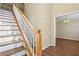 Welcoming foyer with hardwood floors and staircase, adjacent to a dining area at 1039 Megan Ct, Sugar Hill, GA 30518