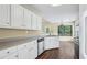 Bright kitchen featuring white cabinets, stainless steel appliances, and a garden view at 1039 Megan Ct, Sugar Hill, GA 30518
