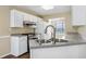 Well-lit kitchen featuring white cabinets, stainless steel appliances, and a practical double sink at 1039 Megan Ct, Sugar Hill, GA 30518