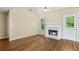 Spacious living room with a cozy fireplace and a ceiling fan at 1039 Megan Ct, Sugar Hill, GA 30518