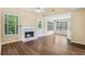 Inviting living room featuring a fireplace, vaulted ceilings, and large windows at 1039 Megan Ct, Sugar Hill, GA 30518