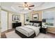 Comfortable main bedroom with hardwood flooring, tray ceilings, and modern décor at 1039 Megan Ct, Sugar Hill, GA 30518
